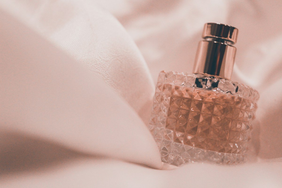 Designer fragrance bottle on soft pink fabric